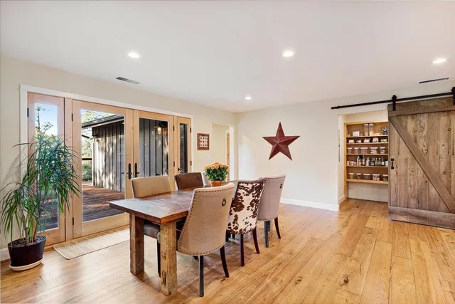 a large bedroom with a bed and large windows