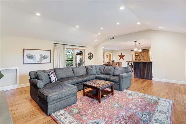 a bathroom with a granite countertop sink a mirror and shower