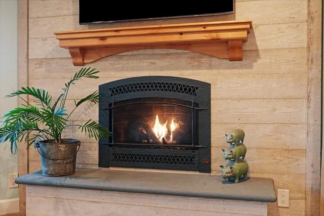 a view of backyard with a table and chairs under a large tree