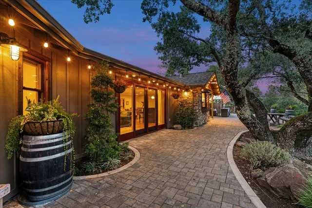 a view of a patio with table and chairs potted plants