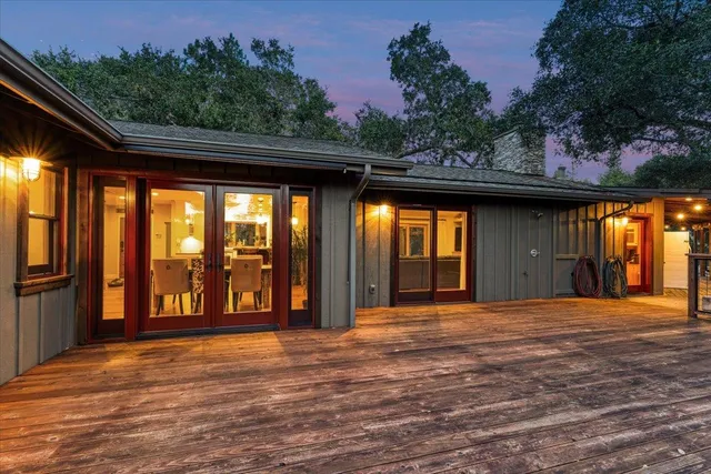 a view of a house with backyard porch and sitting area