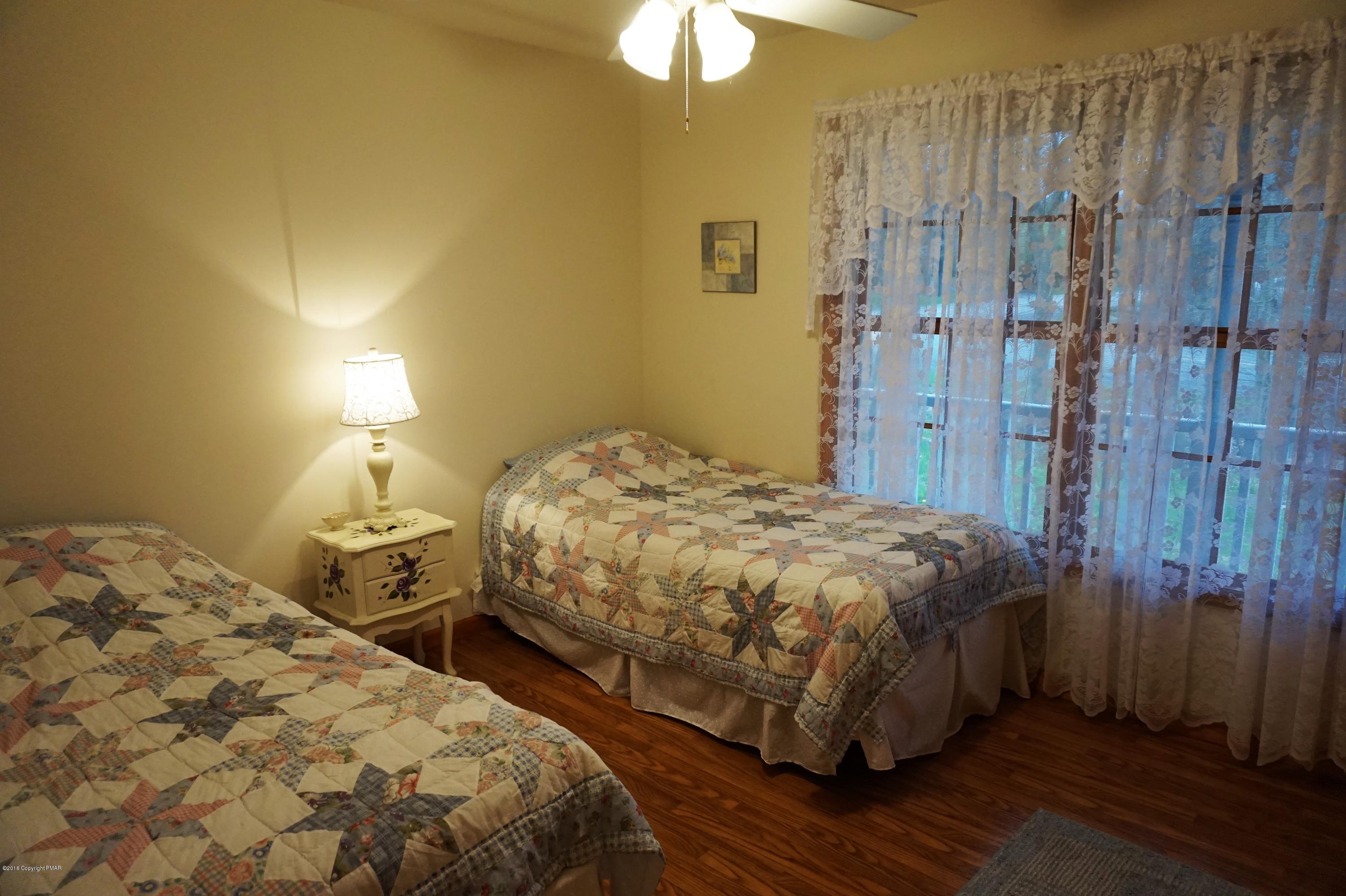 4194 Hickory Road Tobyhanna, PA 18466 - Photo 16 of 29 a bedroom with a bed and a chandelier