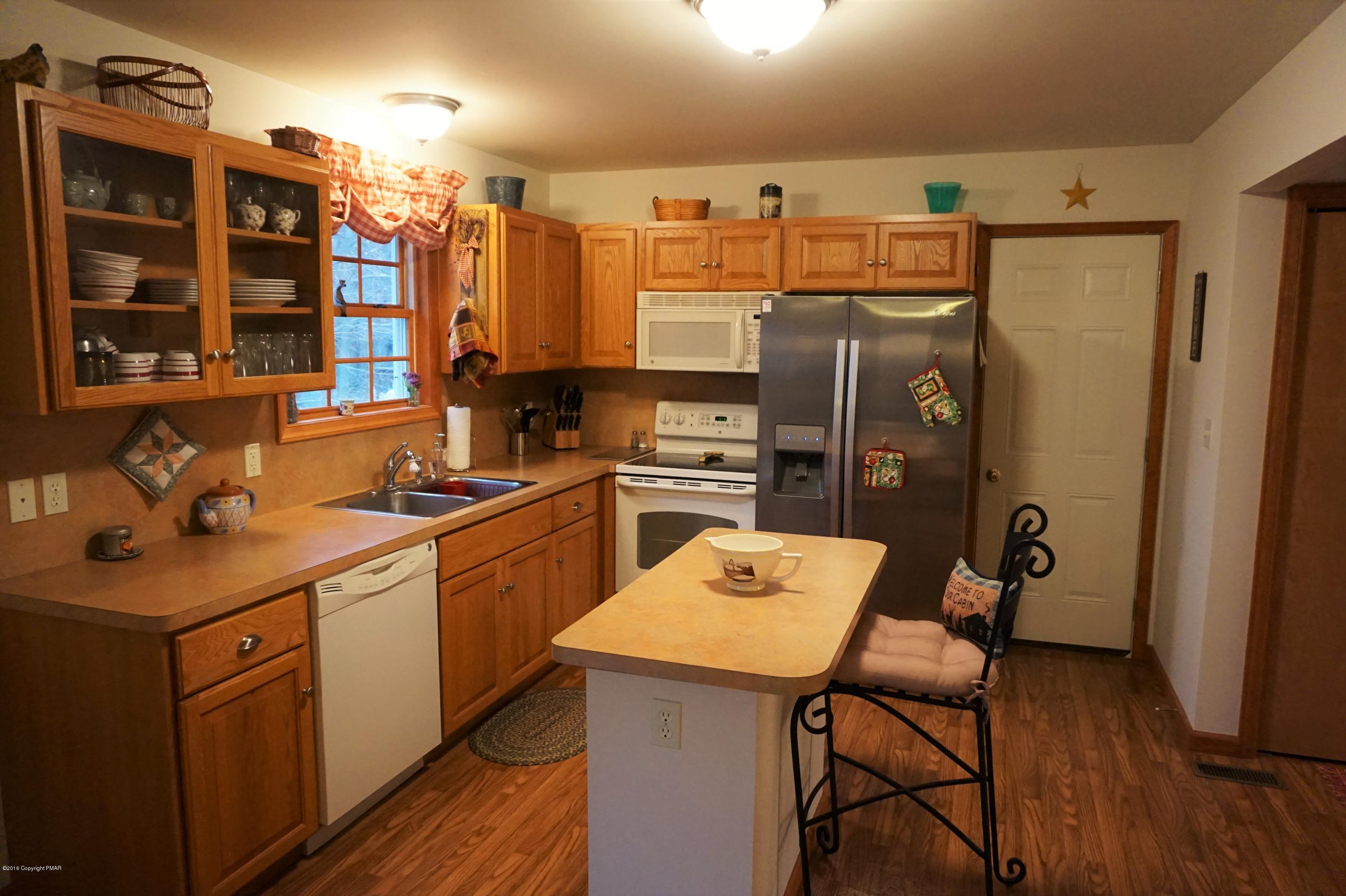 4194 Hickory Road Tobyhanna, PA 18466 - Photo 3 of 29 a kitchen with a sink a counter appliances and cabinets
