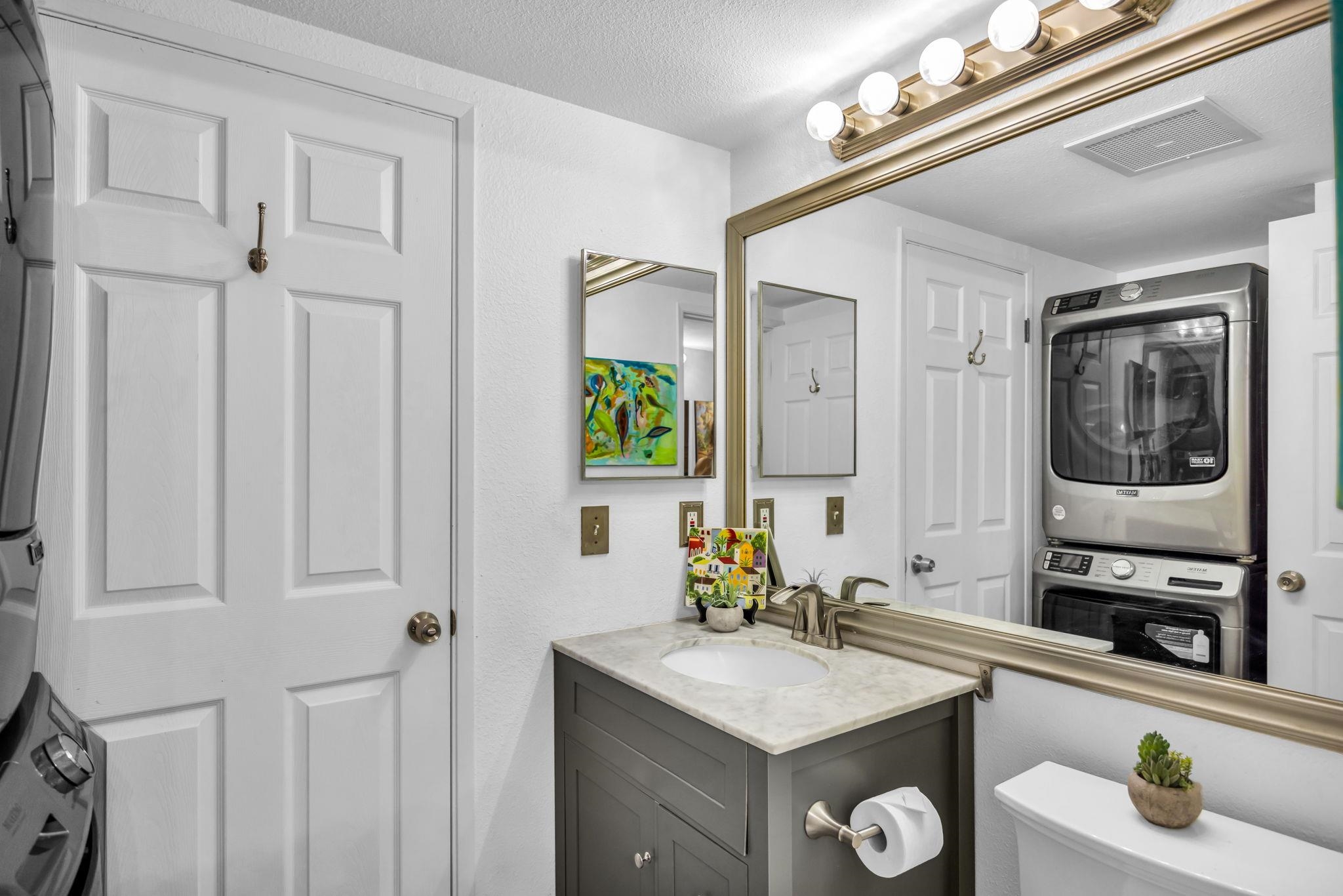 140 Uwapo Road, Unit 36104 Kihei, HI 96753 - Photo 16 of 33 a bathroom with a sink a vanity and a mirror