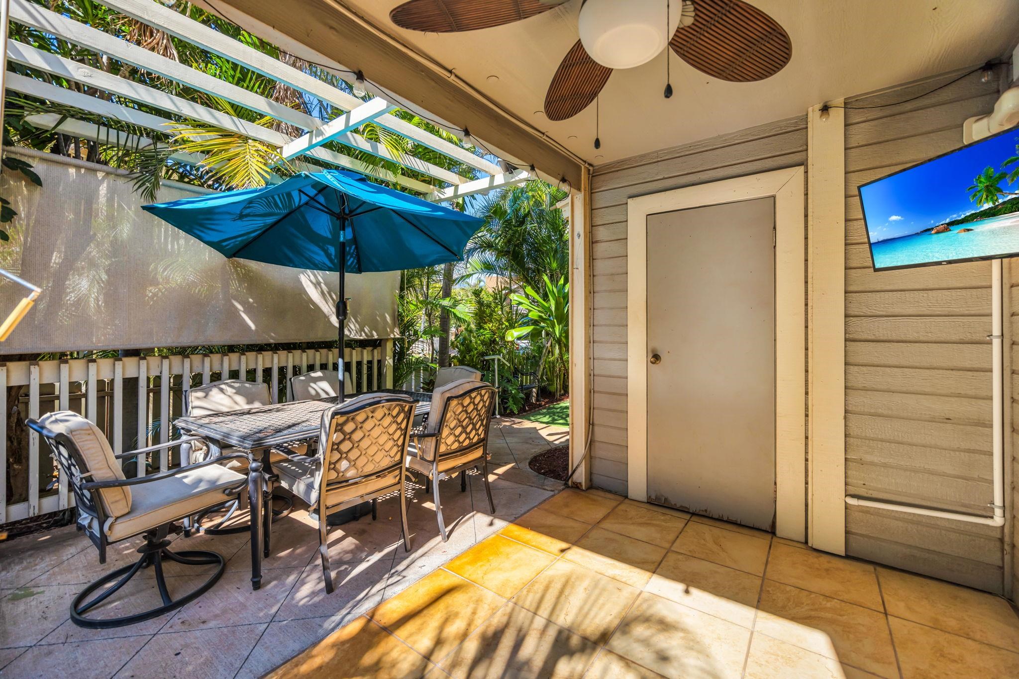 140 Uwapo Road, Unit 36104 Kihei, HI 96753 - Photo 25 of 33 a view of a patio with a table and chairs under an umbrella