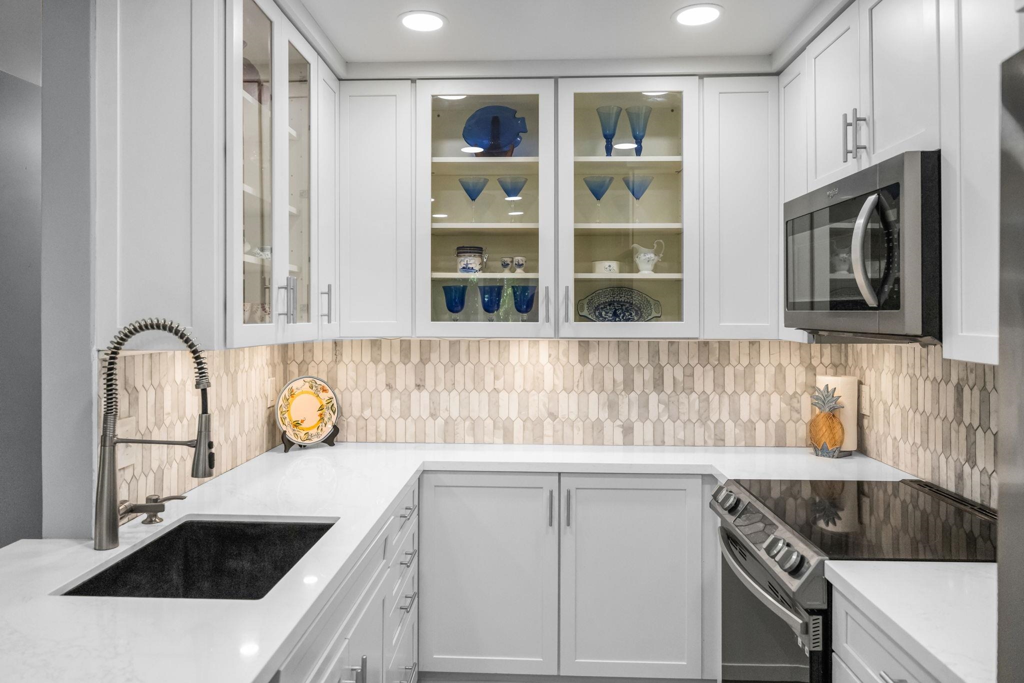140 Uwapo Road, Unit 36104 Kihei, HI 96753 - Photo 3 of 33 a kitchen with granite countertop stainless steel appliances a sink and cabinets