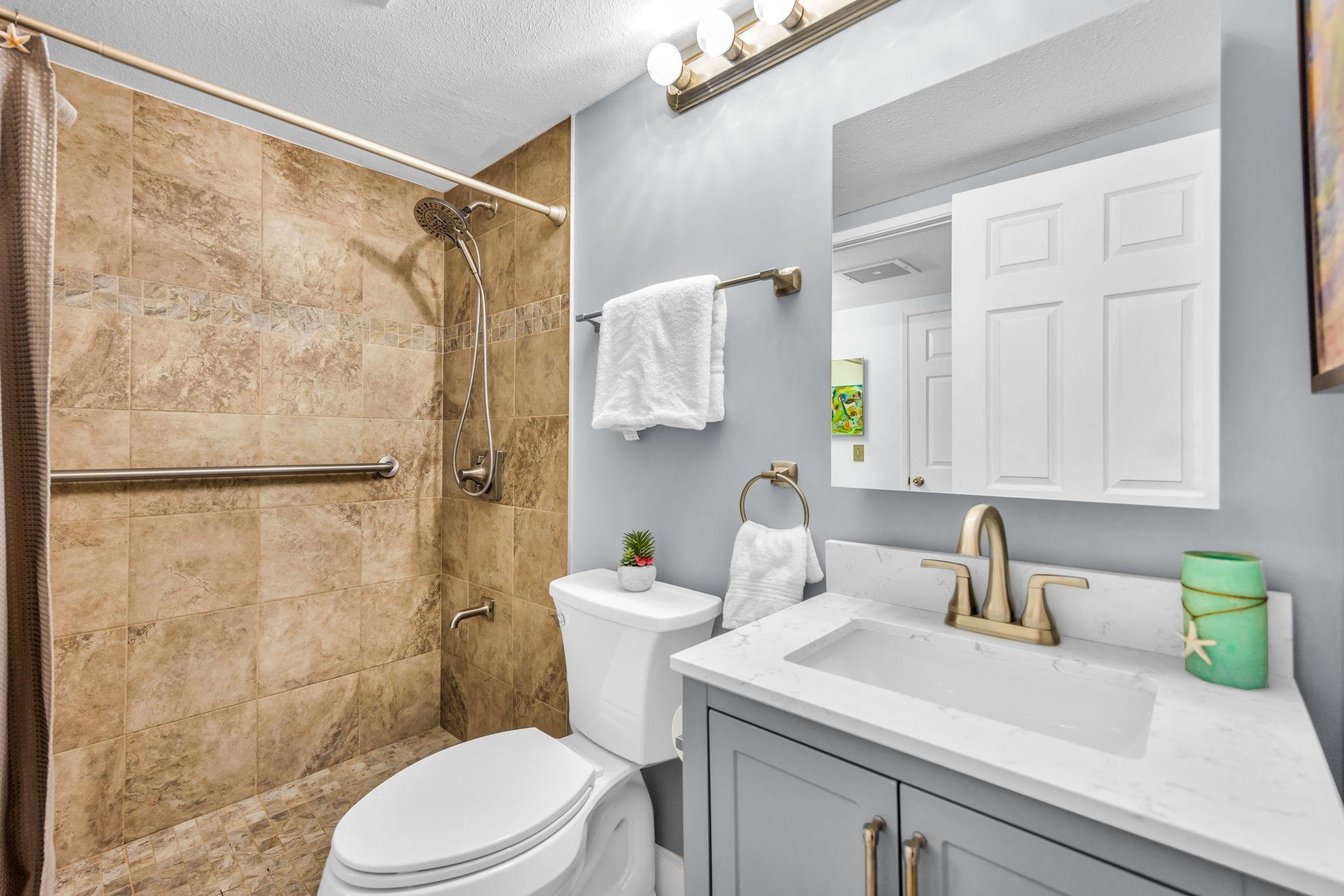 140 Uwapo Road, Unit 36104 Kihei, HI 96753 - Photo 6 of 33 a bathroom with a sink a toilet and shower