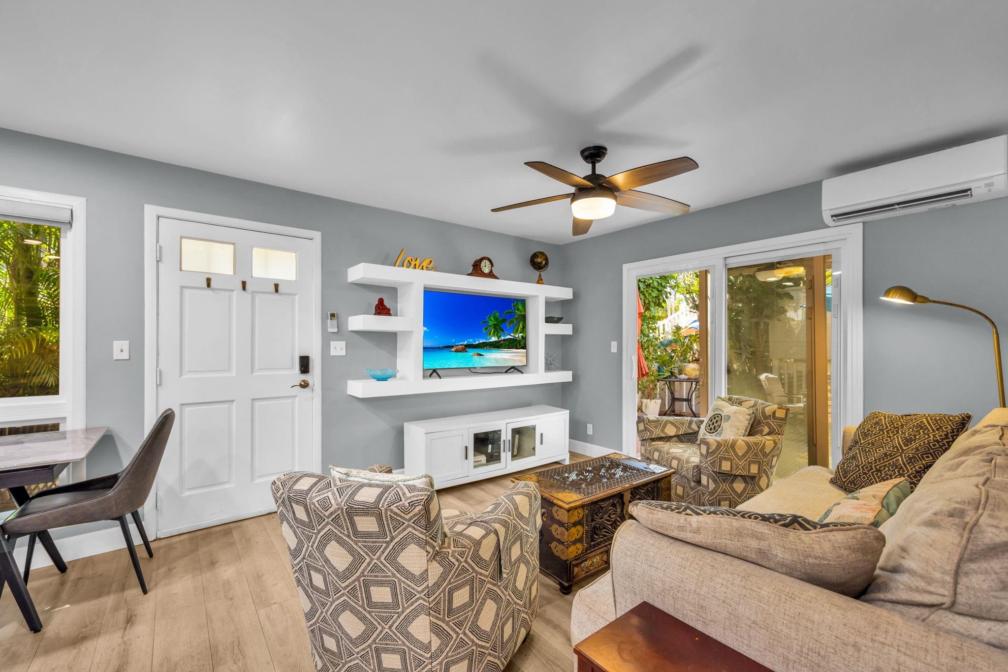 140 Uwapo Road, Unit 36104 Kihei, HI 96753 - Photo 7 of 33 a living room with furniture a fireplace and a large window