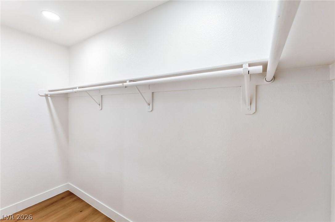 668 Rising Brook Drive Henderson, NV 89011 - Photo 13 of 22 A well-lit closet offers ample hanging space for organized storage.