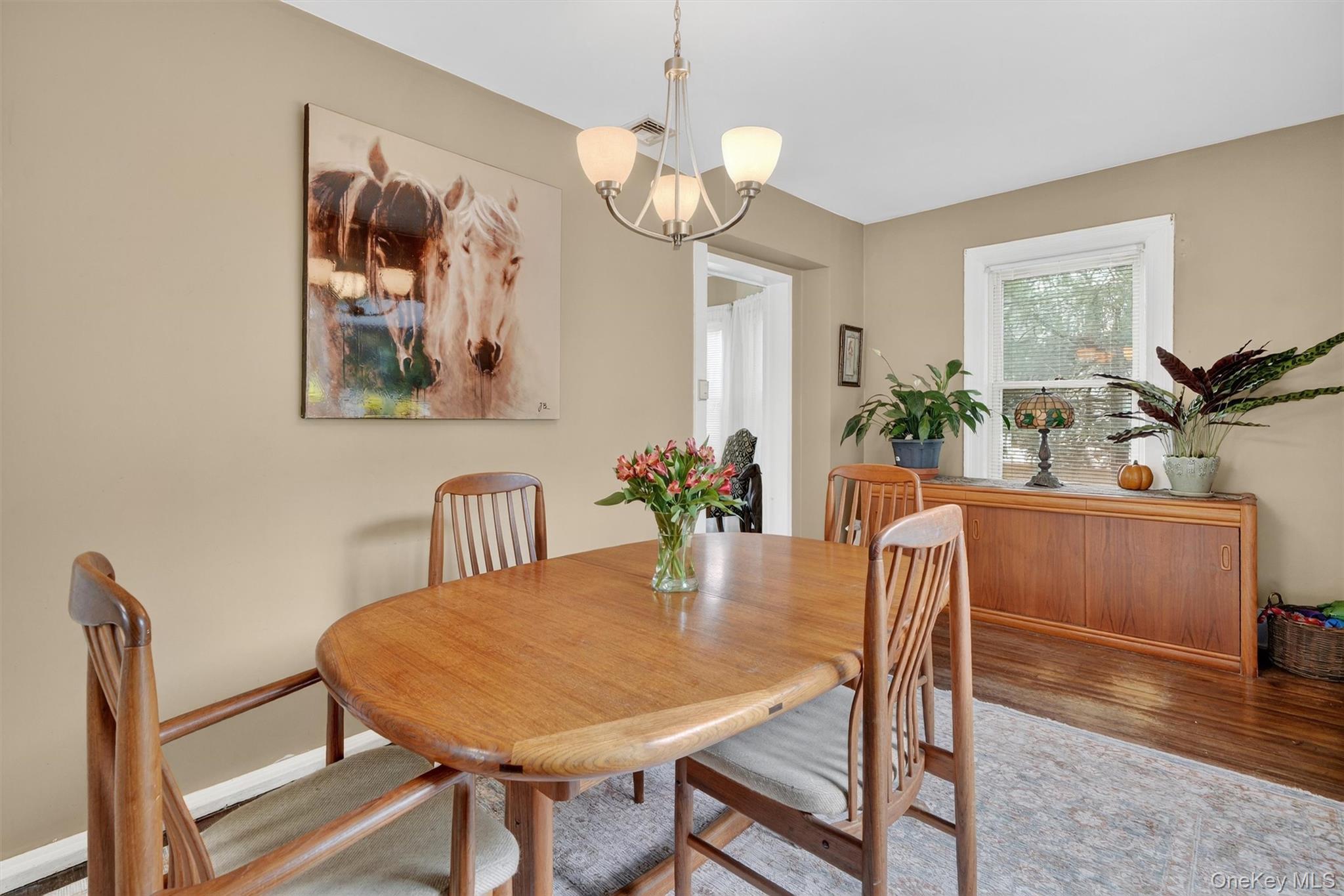 134 Dalmeny Road Briarcliff Manor, NY 10510 - Photo 12 of 44 a view of a dining room with furniture wooden floor and a chandelier