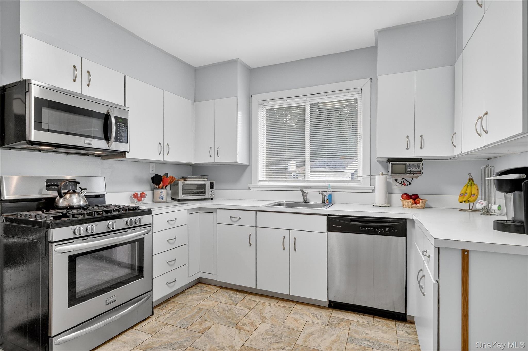134 Dalmeny Road Briarcliff Manor, NY 10510 - Photo 15 of 44 a kitchen with cabinets stainless steel appliances a sink and a window