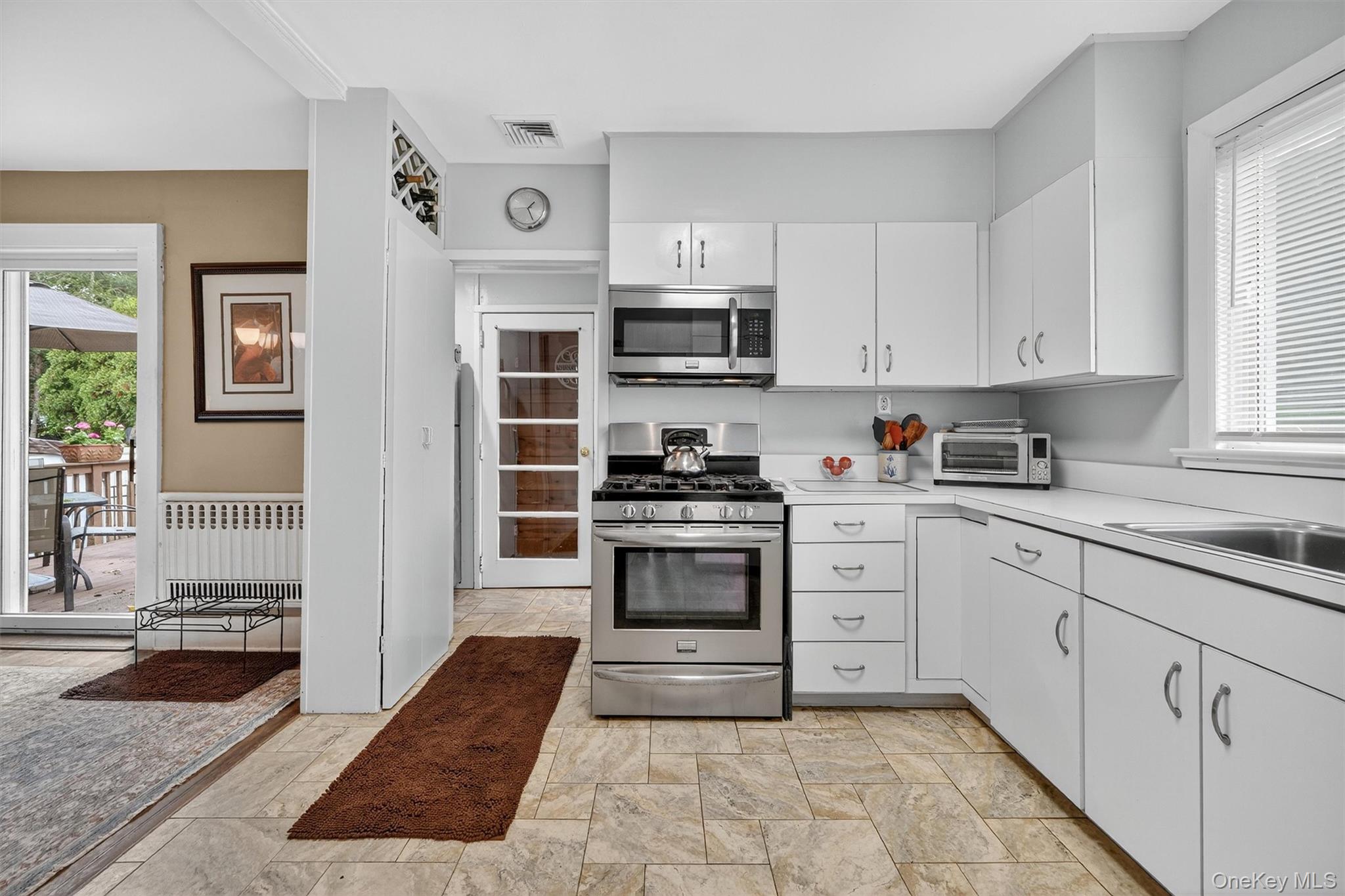 134 Dalmeny Road Briarcliff Manor, NY 10510 - Photo 16 of 44 a kitchen with stainless steel appliances granite countertop a stove and cabinets