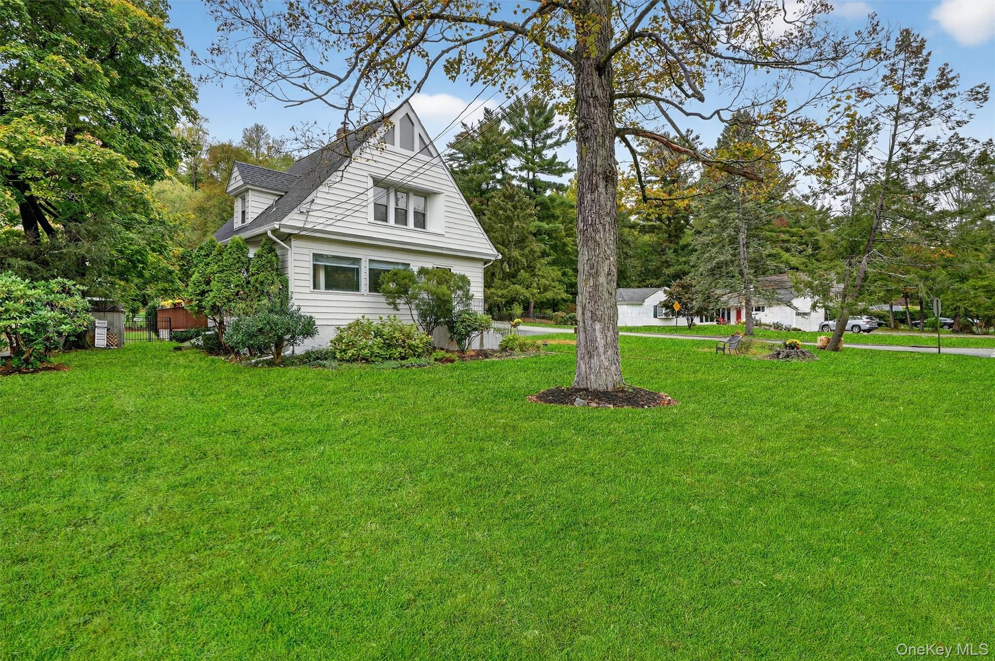 134 Dalmeny Road Briarcliff Manor, NY 10510 - Photo 2 of 44 a front view of a house with garden and trees