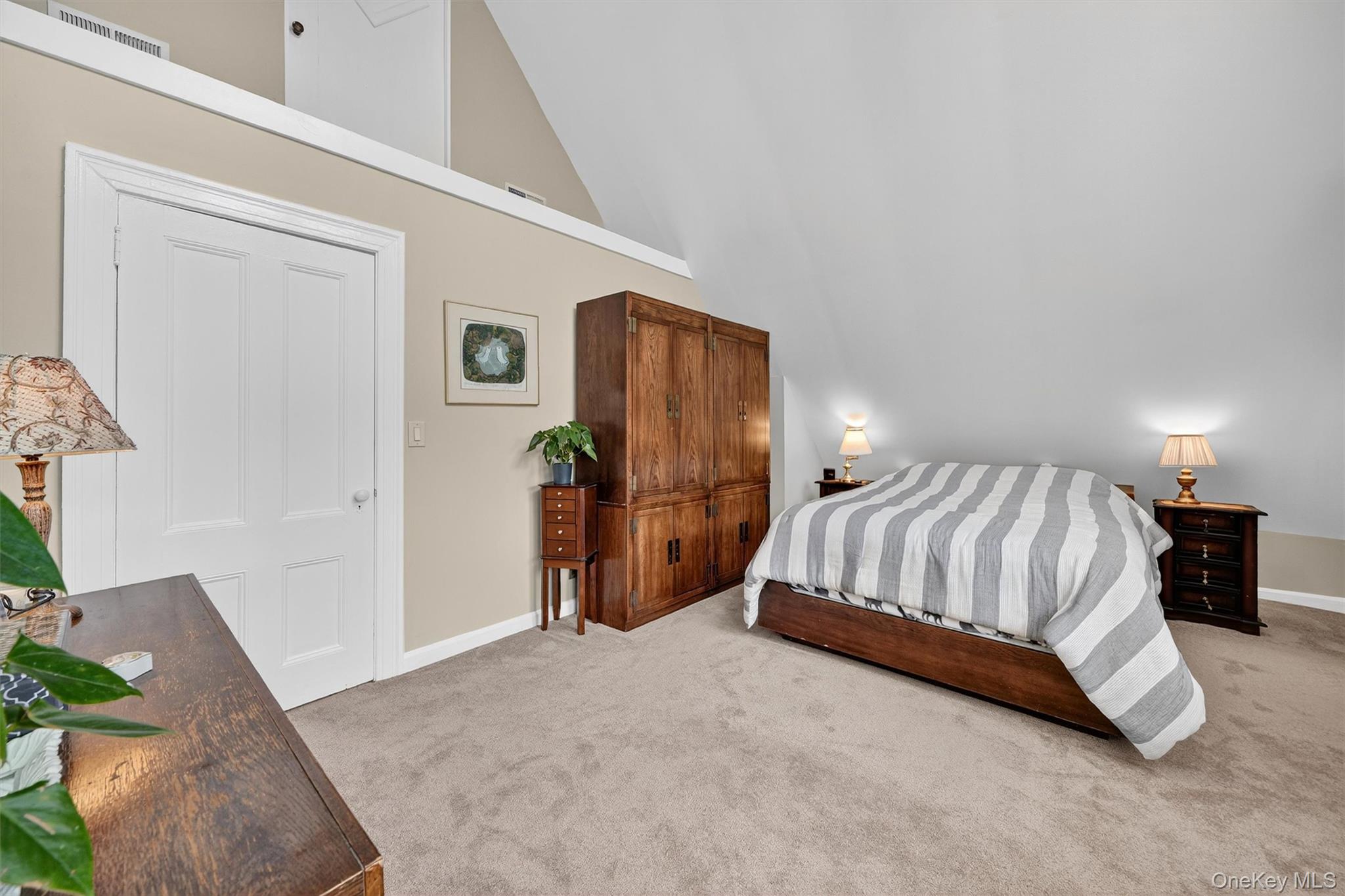 134 Dalmeny Road Briarcliff Manor, NY 10510 - Photo 27 of 44 a spacious bedroom with a bed and a lamp