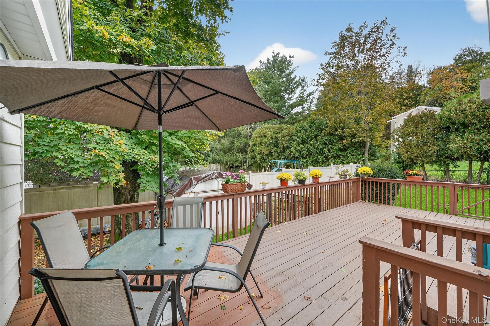 134 Dalmeny Road Briarcliff Manor, NY 10510 - Photo 34 of 44 a view of a balcony with furniture and umbrella