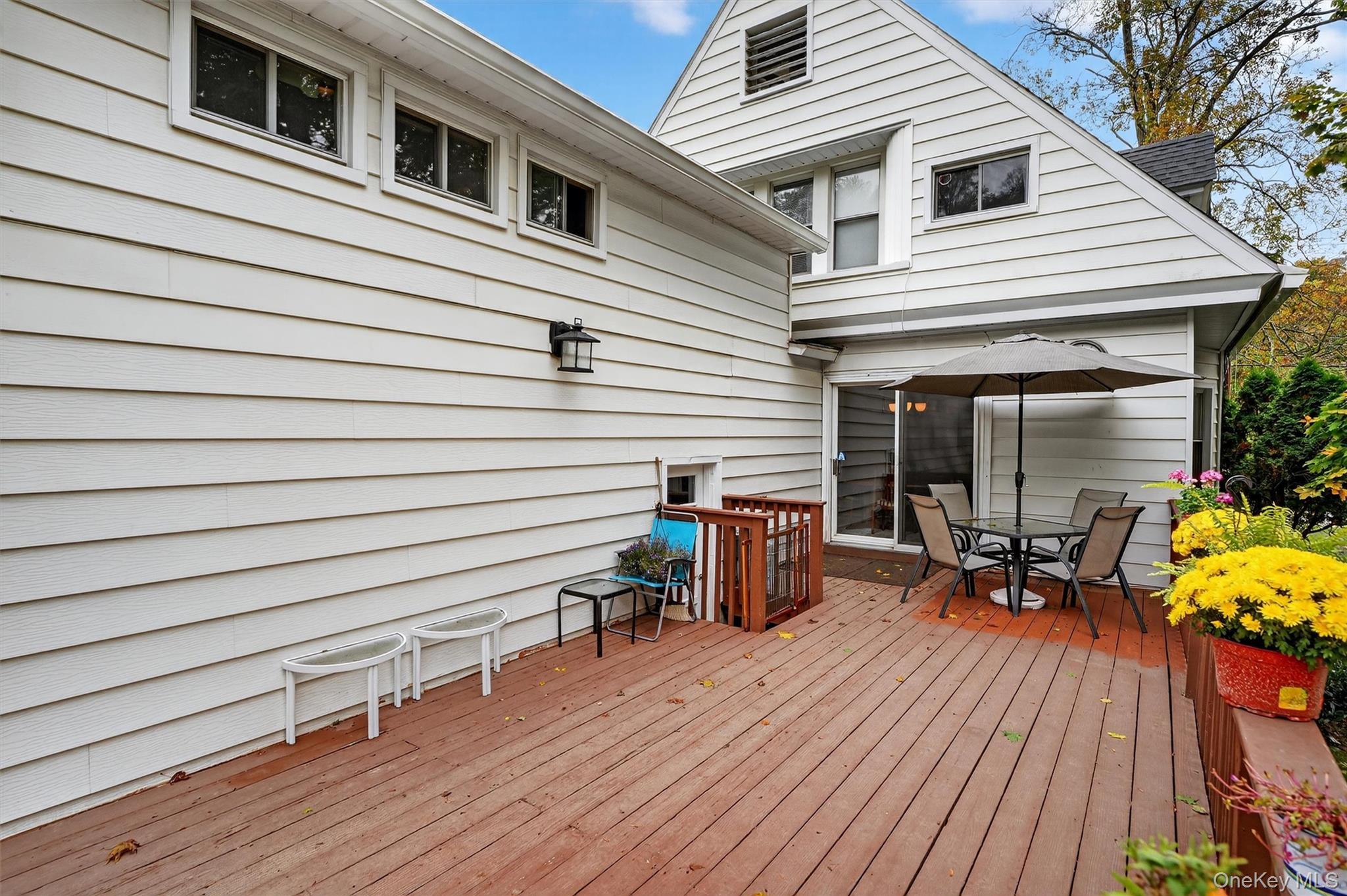 134 Dalmeny Road Briarcliff Manor, NY 10510 - Photo 36 of 44 a view of a patio with chairs and table on wooden floor