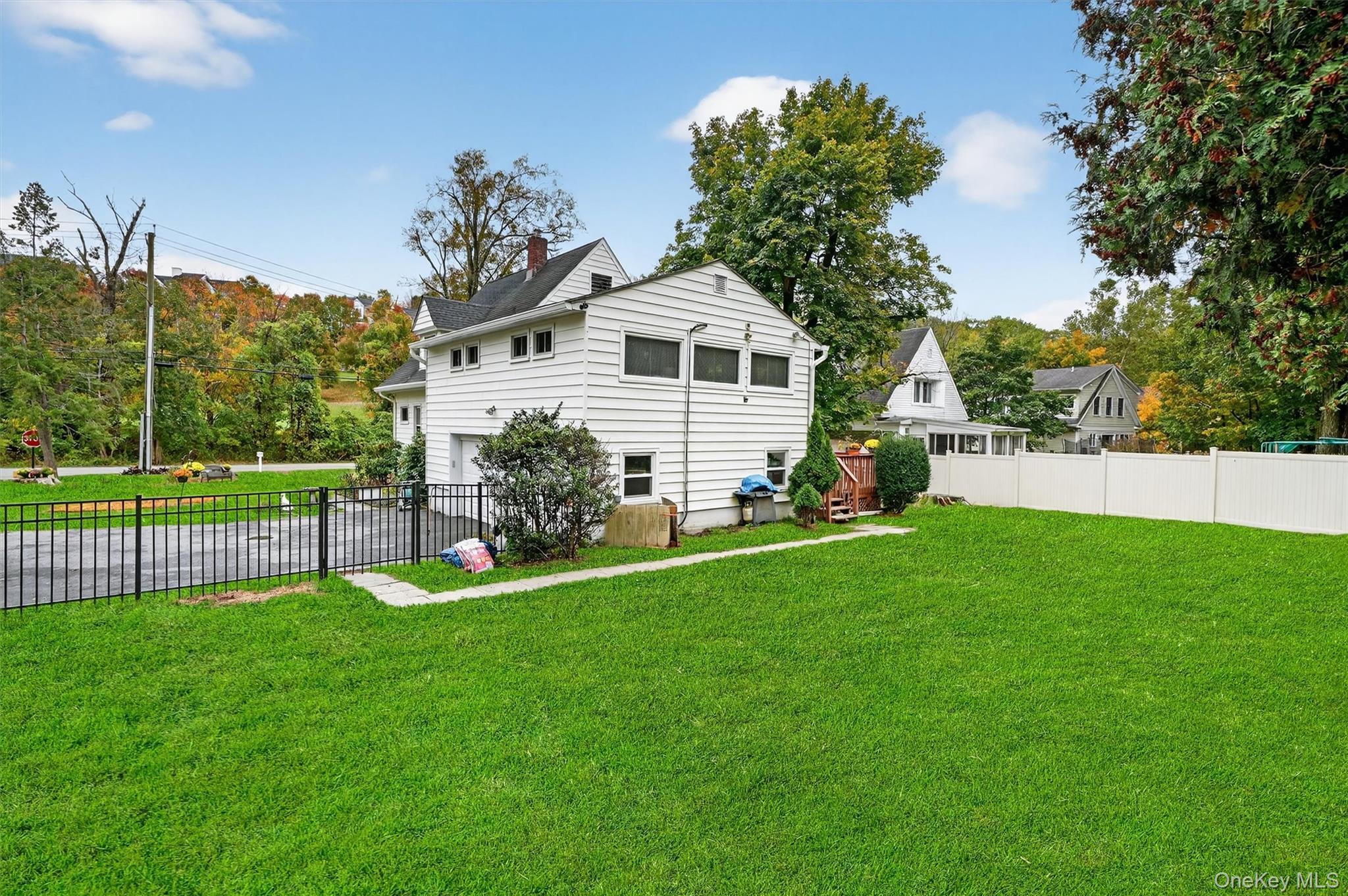 134 Dalmeny Road Briarcliff Manor, NY 10510 - Photo 38 of 44 a view of a house with a yard and a garden
