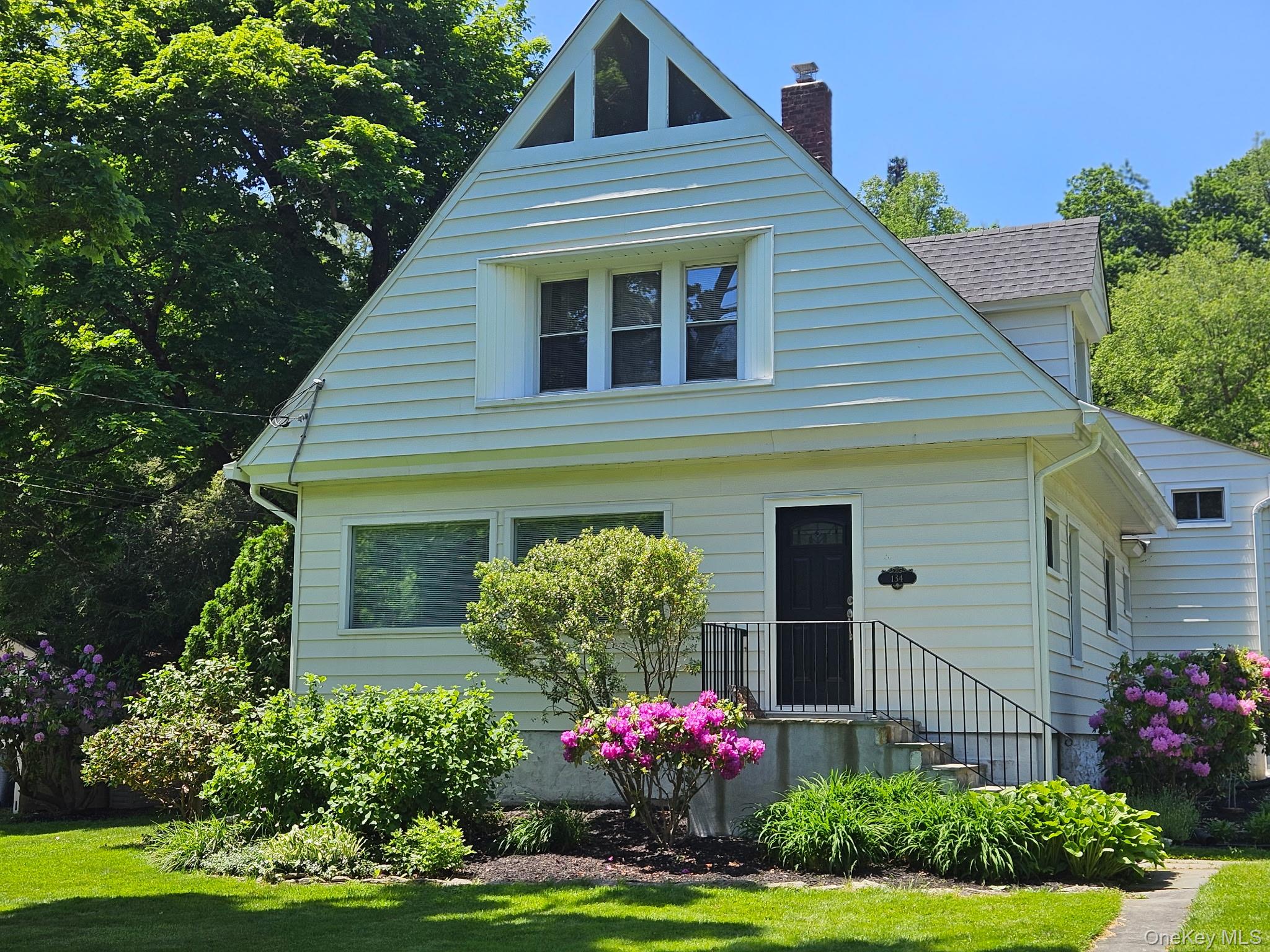 134 Dalmeny Road Briarcliff Manor, NY 10510 - Photo 43 of 44 a front view of a house with a yard and potted plants