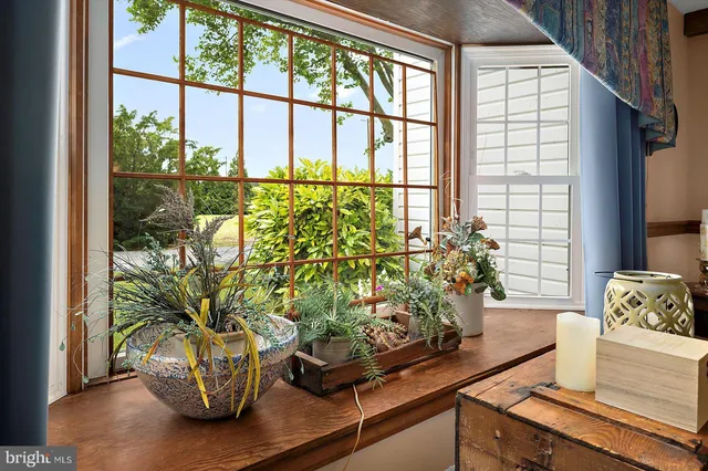 a dining room with furniture window and wooden floor