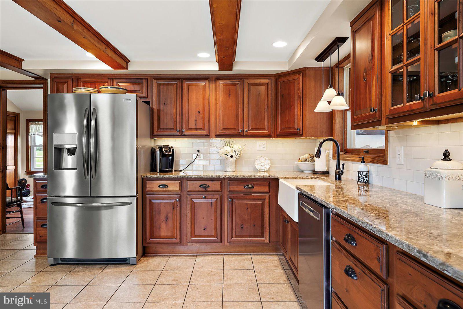 8807 Woodland Ferry Road Laurel, DE 19956 - Photo 23 of 90 a kitchen with stainless steel appliances granite countertop a refrigerator a sink and a stove