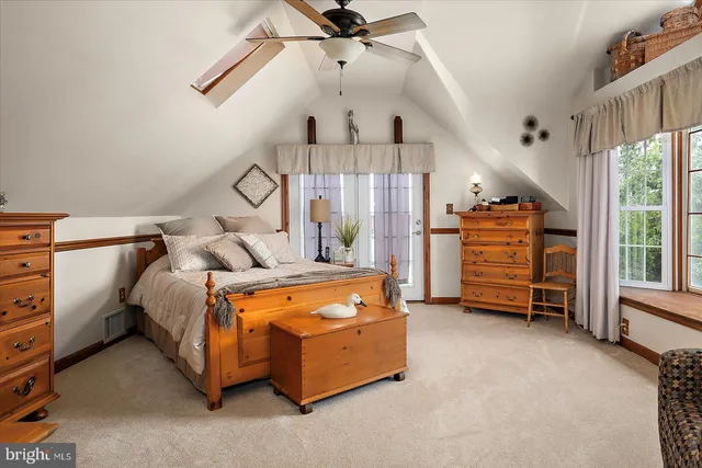 a view of a dining room with furniture large windows and wooden floor