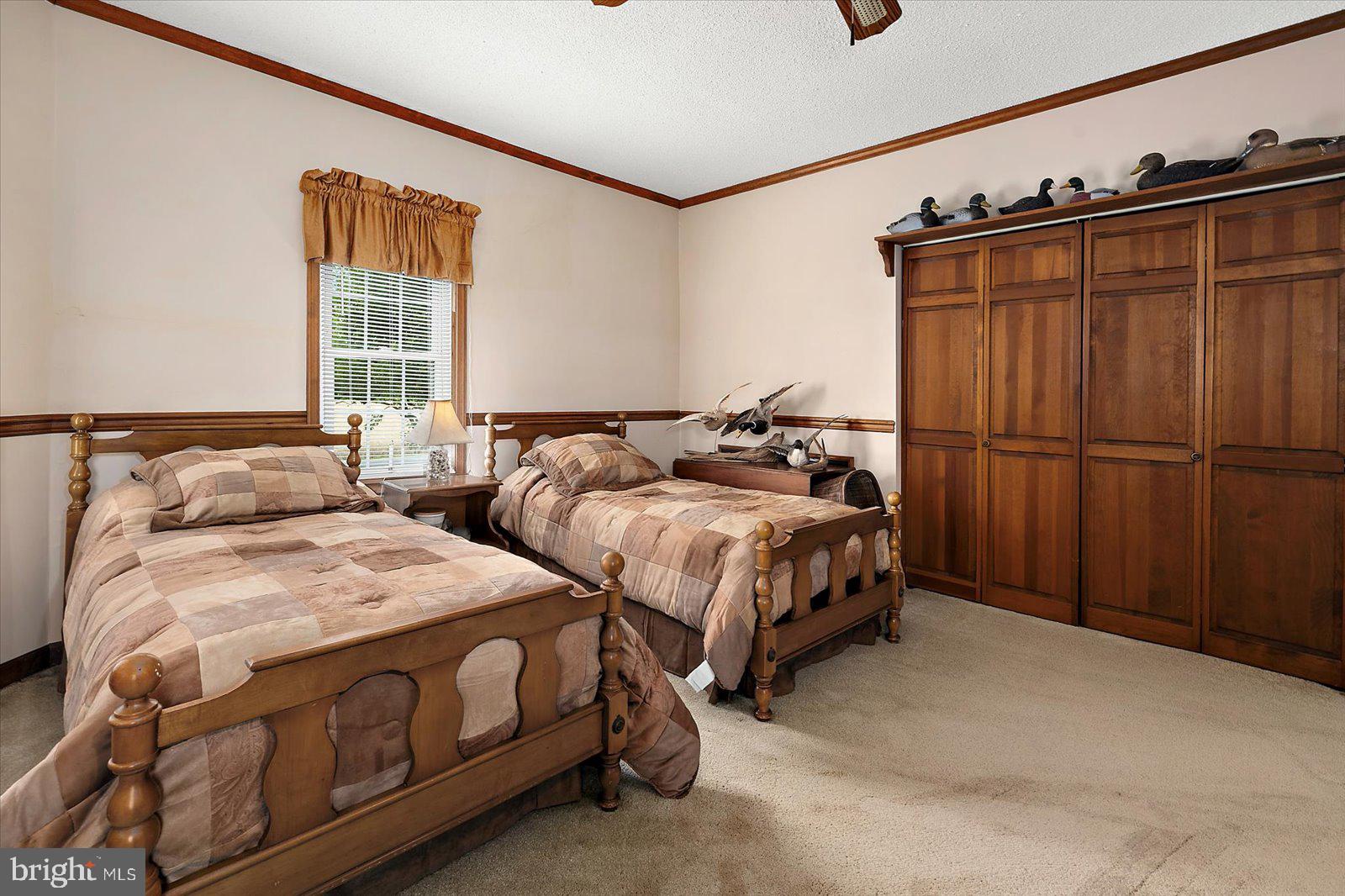8807 Woodland Ferry Road Laurel, DE 19956 - Photo 49 of 90 a bedroom with two beds and a closet