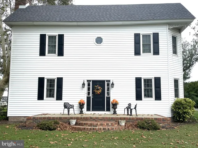 a view of a bedroom with furniture and windows