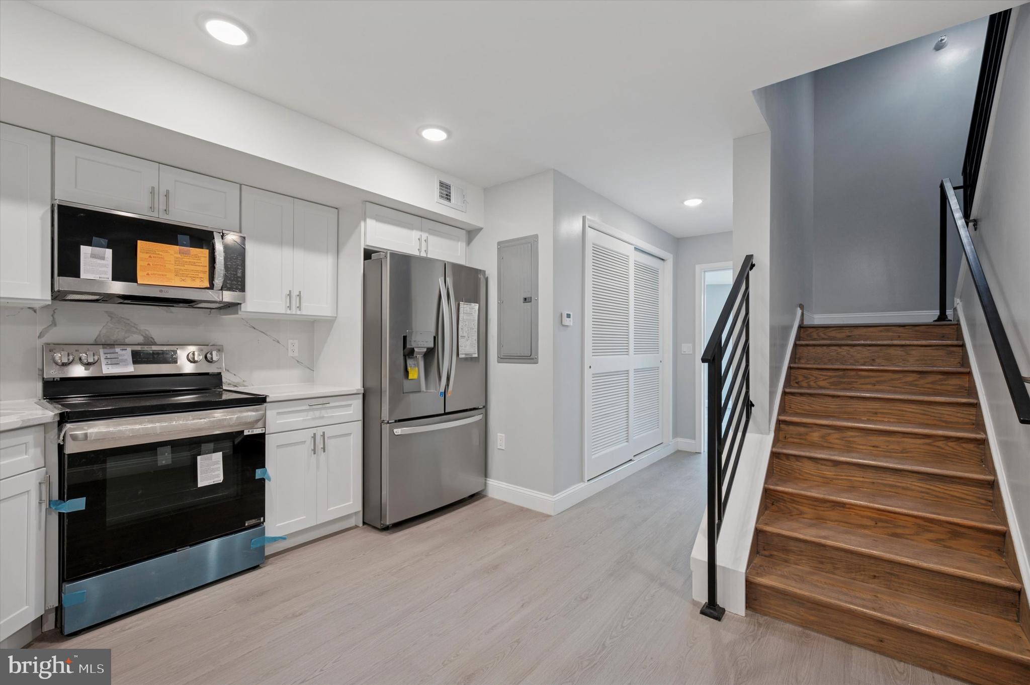 2405 Ridge Avenue, Unit 3 Philadelphia, PA 19121 - Photo 3 of 11 a kitchen with stainless steel appliances kitchen island granite countertop a refrigerator and a stove top oven