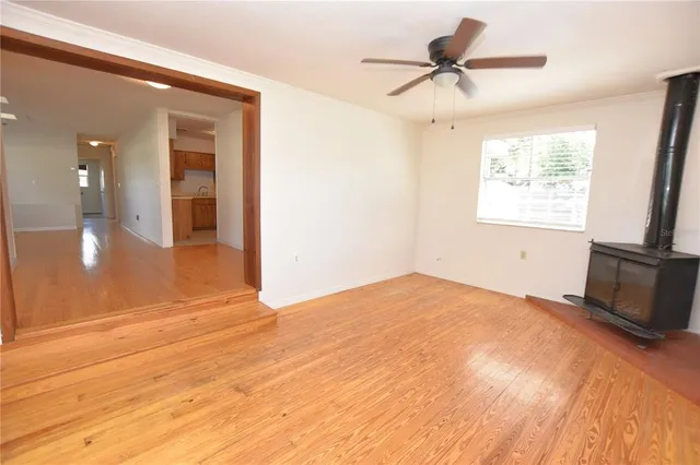 a view of a livingroom with a ceiling fan and window