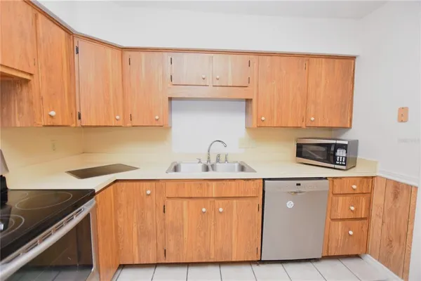 a kitchen with cabinets appliances and a sink