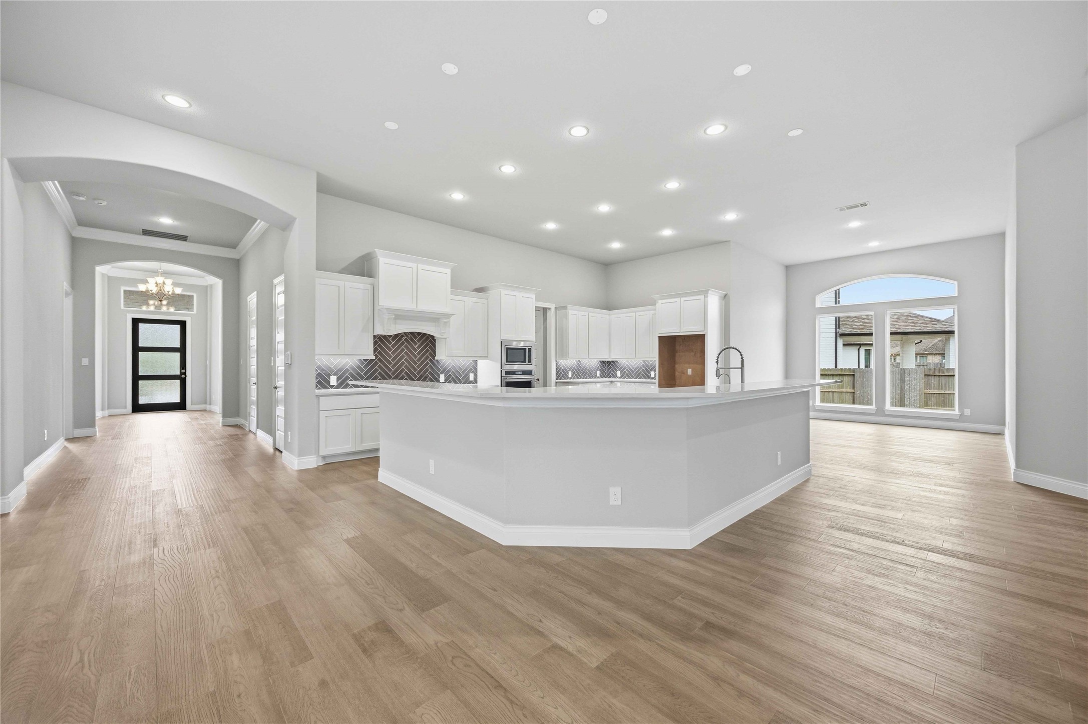 17564 Watercolor Way Conroe, TX 77302 - Photo 14 of 42 Chef's kitchen with quartz counter tops, stylish backsplash, expansive island, stainless steel appliances and walk in pantry