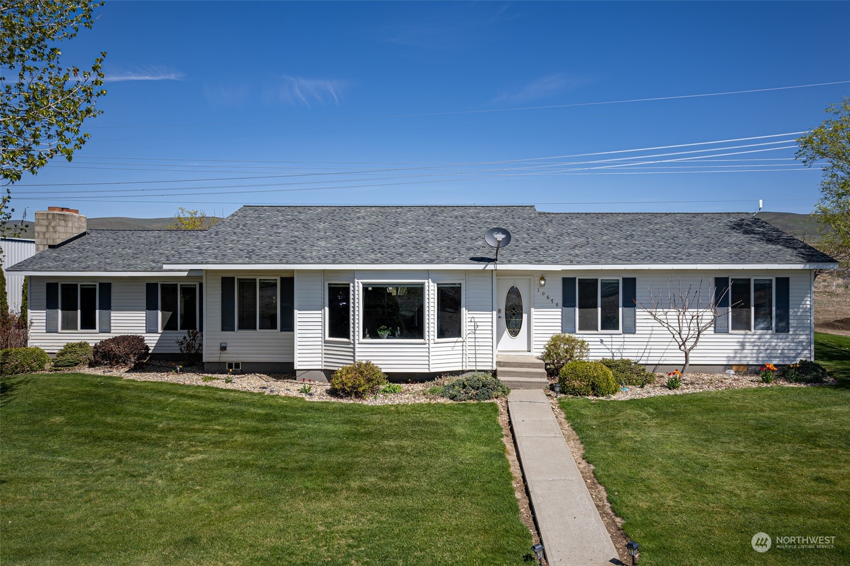 a front view of house with a garden and patio
