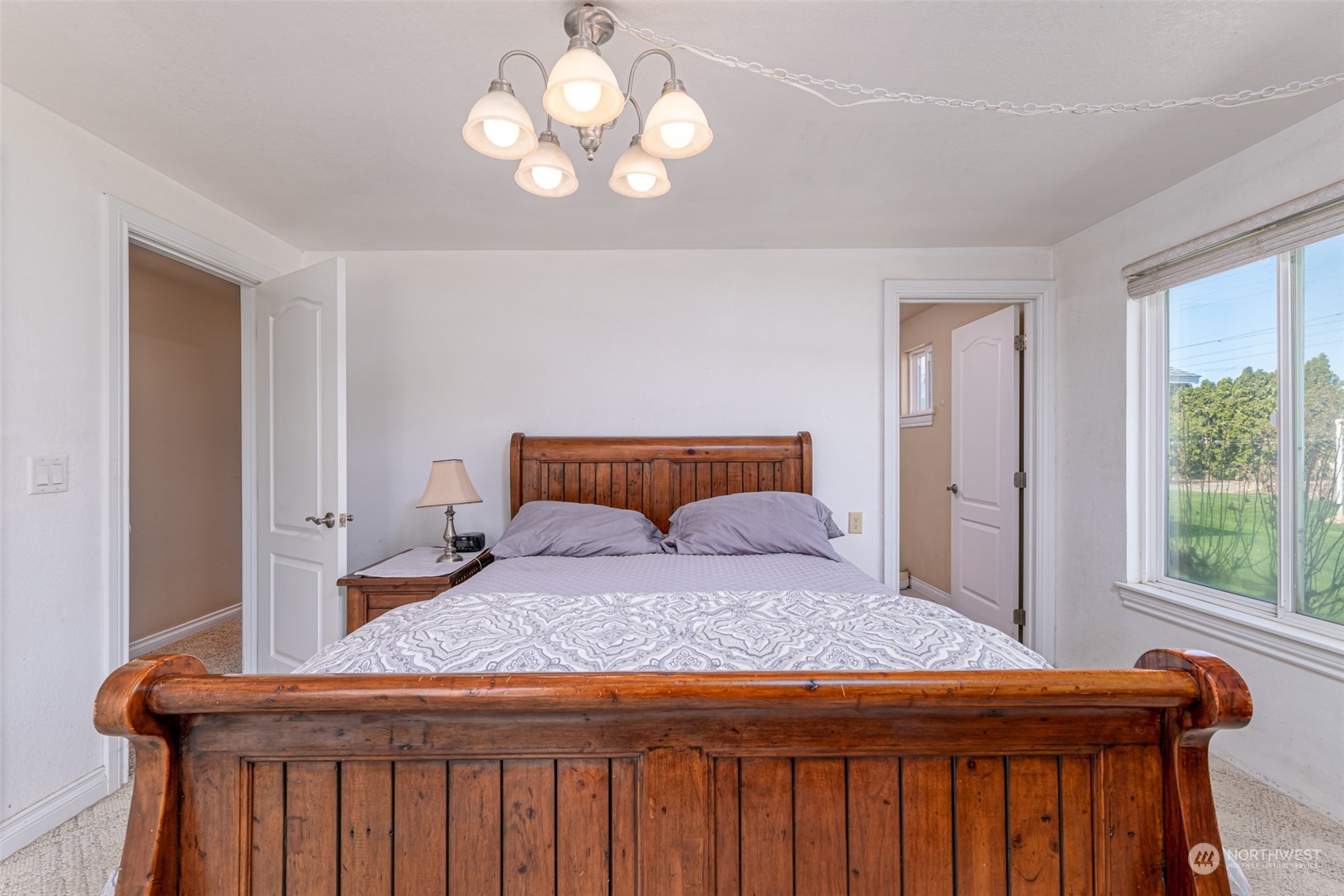 10676 13th Road Northwest Quincy, WA 98848 - Photo 15 of 34 a bedroom with a large bed and a chandelier