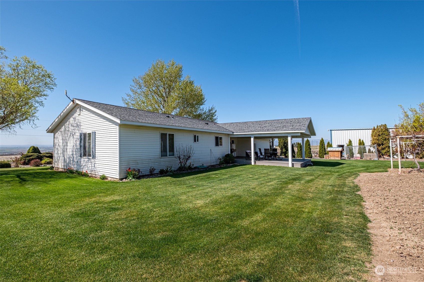 10676 13th Road Northwest Quincy, WA 98848 - Photo 24 of 34 a view of a yard in front of a house with a large tree