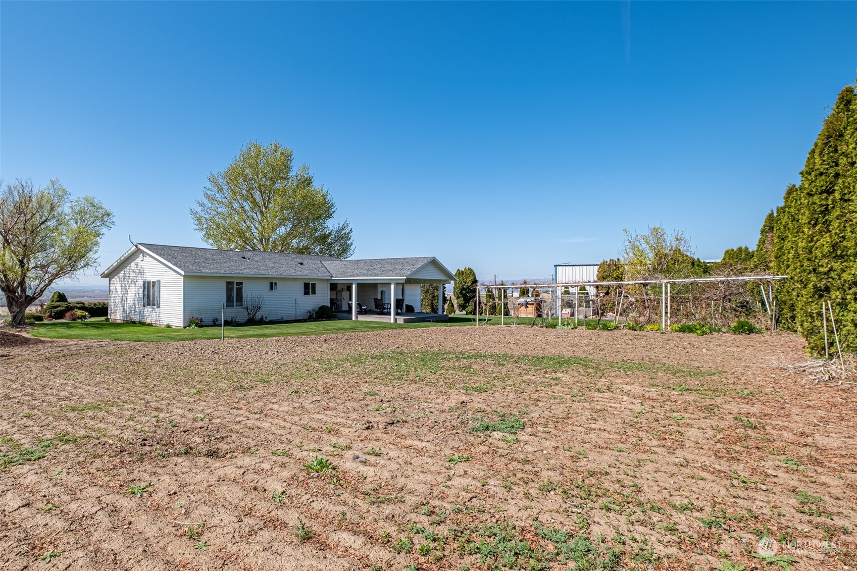 10676 13th Road Northwest Quincy, WA 98848 - Photo 25 of 34 a front view of a house with a yard and garage