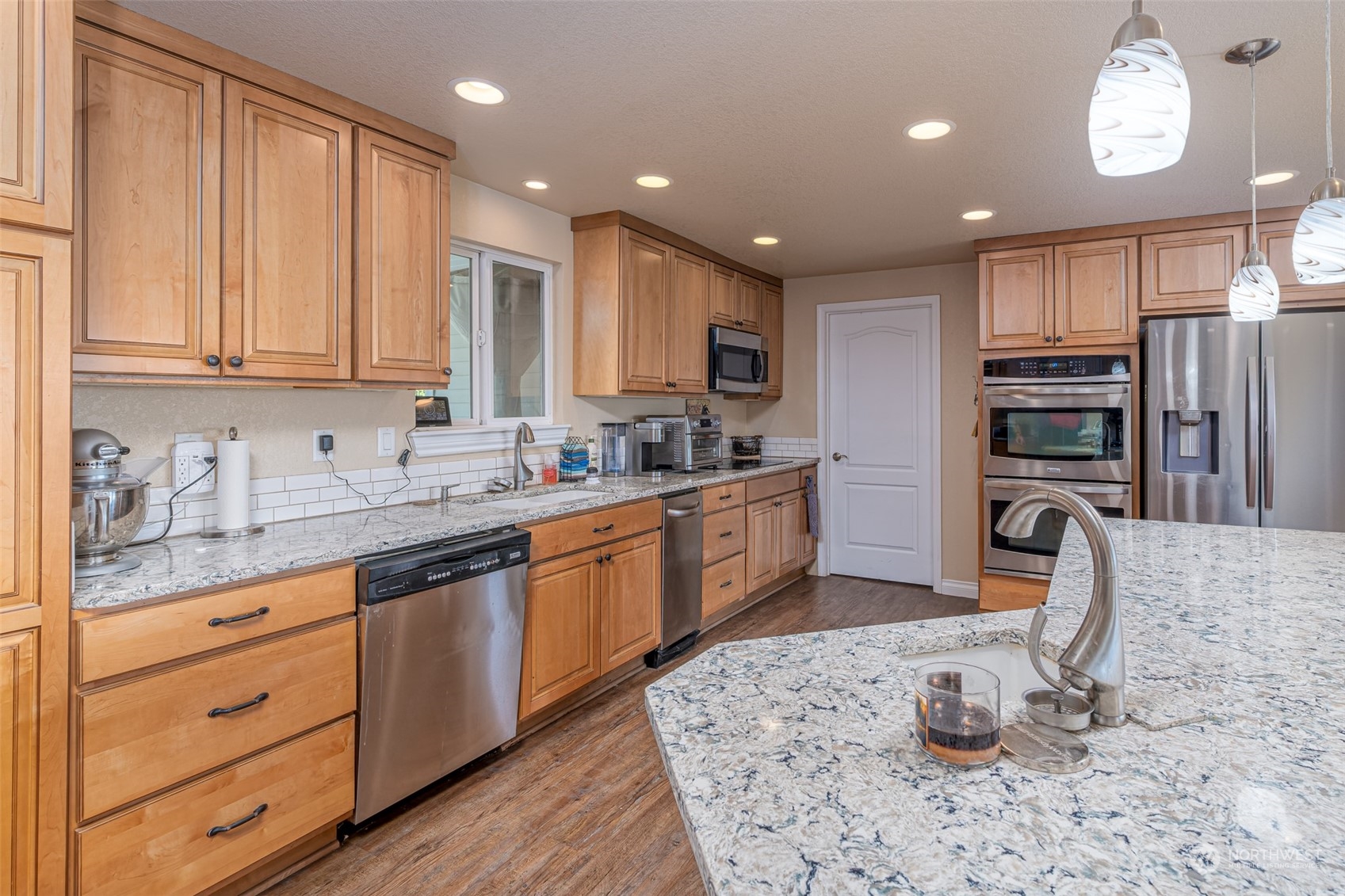 10676 13th Road Northwest Quincy, WA 98848 - Photo 7 of 34 a kitchen with stainless steel appliances kitchen island granite countertop a sink and cabinets