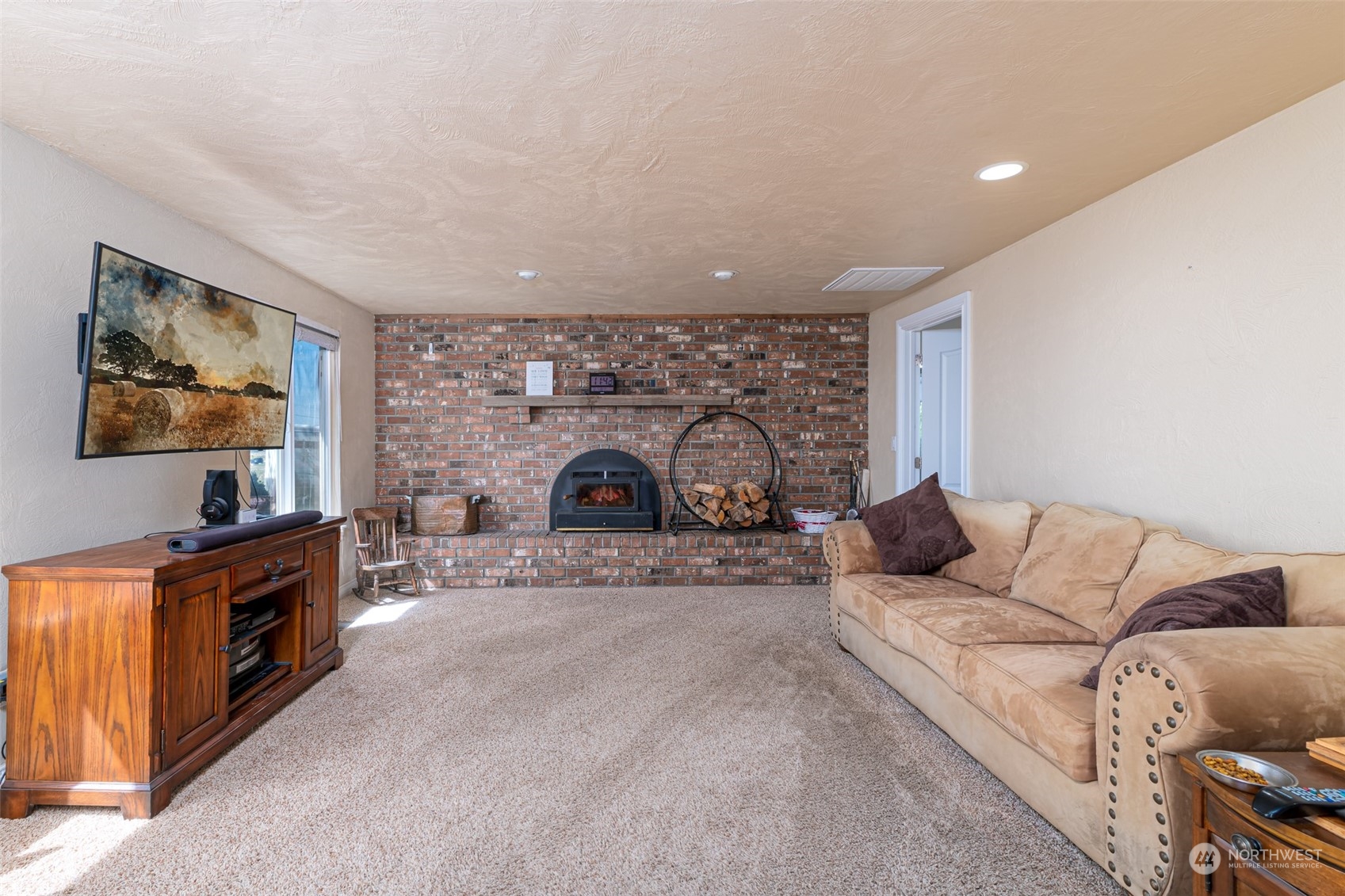 10676 13th Road Northwest Quincy, WA 98848 - Photo 8 of 34 a living room with furniture a fireplace and a flat screen tv