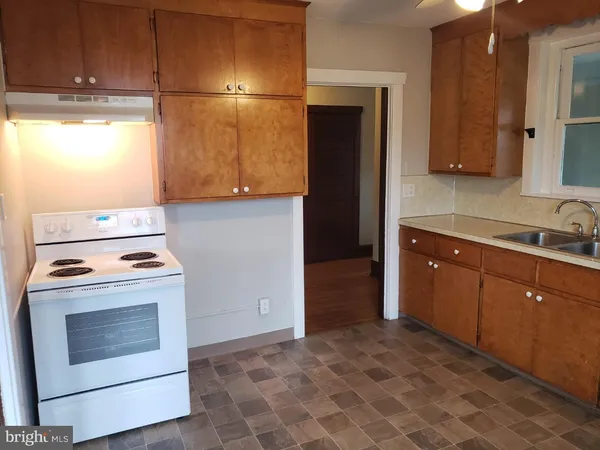 a kitchen with a stove and a refrigerator
