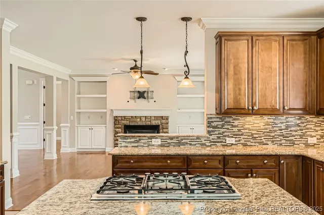 a kitchen with stainless steel appliances granite countertop a stove a sink and a microwave