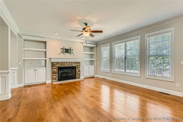 a view of an empty room with a fireplace and a window