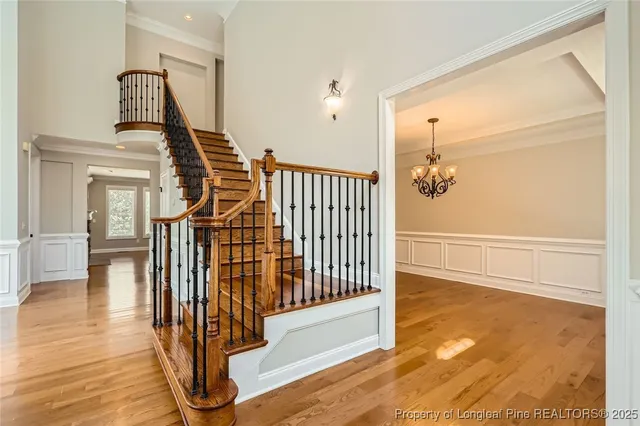 a view of entryway and hall with wooden floor