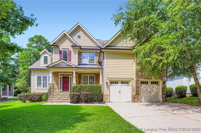 a front view of a house with a yard and porch