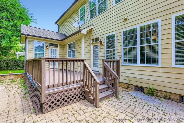 a roof deck with a table and chairs