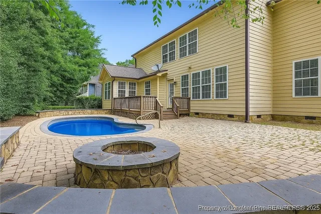 a view of a house with pool and chairs