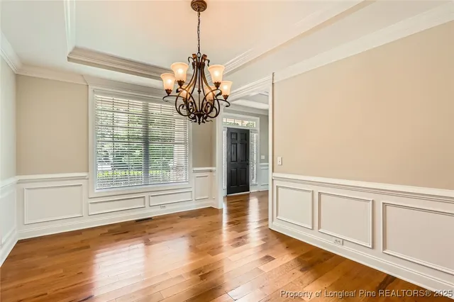 a view of a room with wooden floor and windows