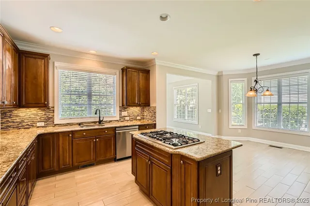 a kitchen with a stove sink and cabinets