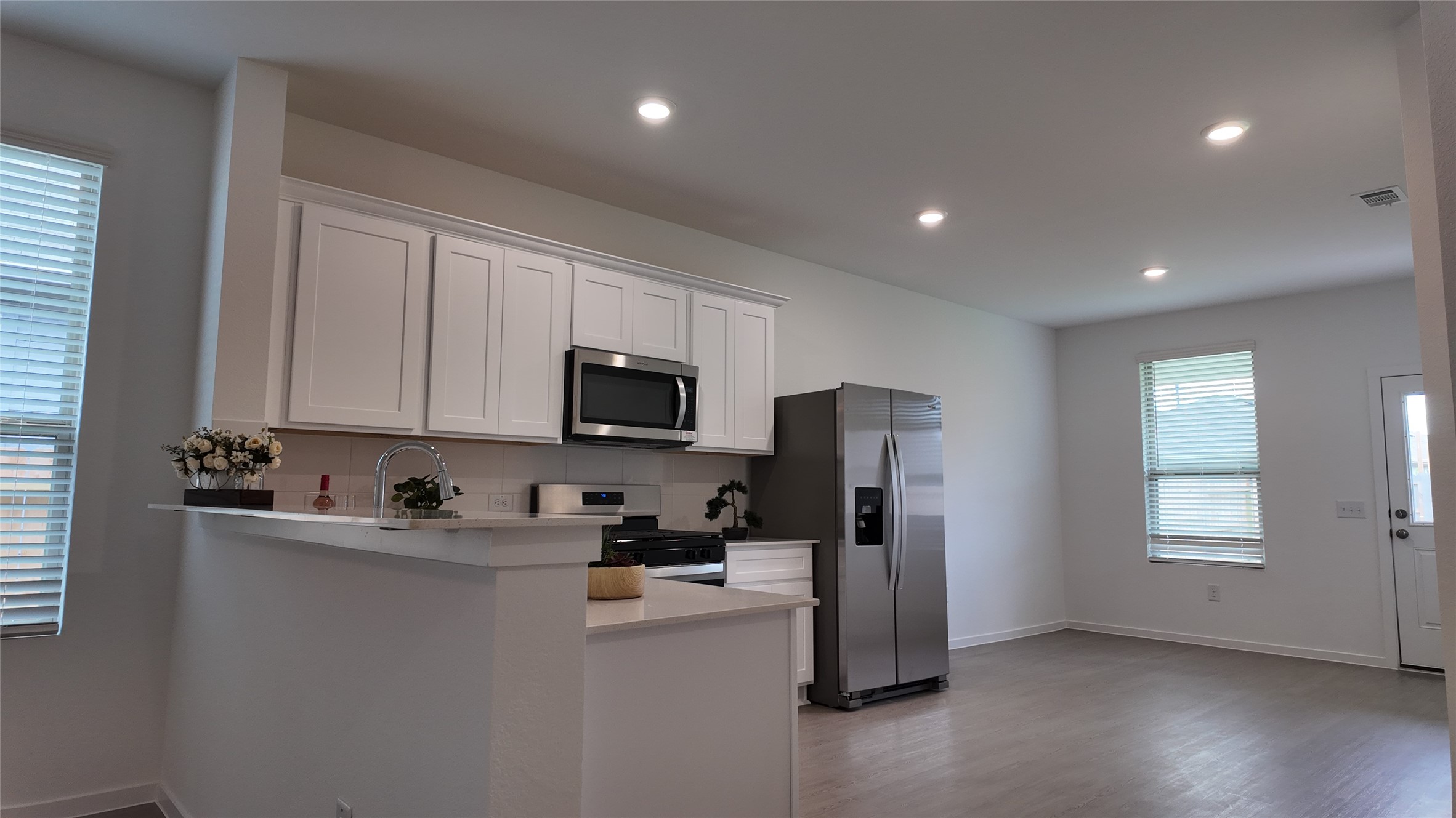 15023 Rustic Moon Road Conroe, TX 77302 - Photo 4 of 18 a kitchen with stainless steel appliances a refrigerator a sink a stove a microwave and cabinets