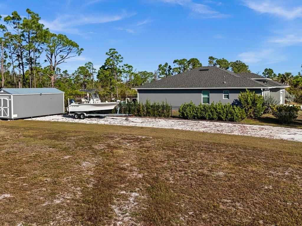 8221 Agate Street Port Charlotte, FL 33981 - Photo 11 of 50 a front view of a house with a yard and potted plants