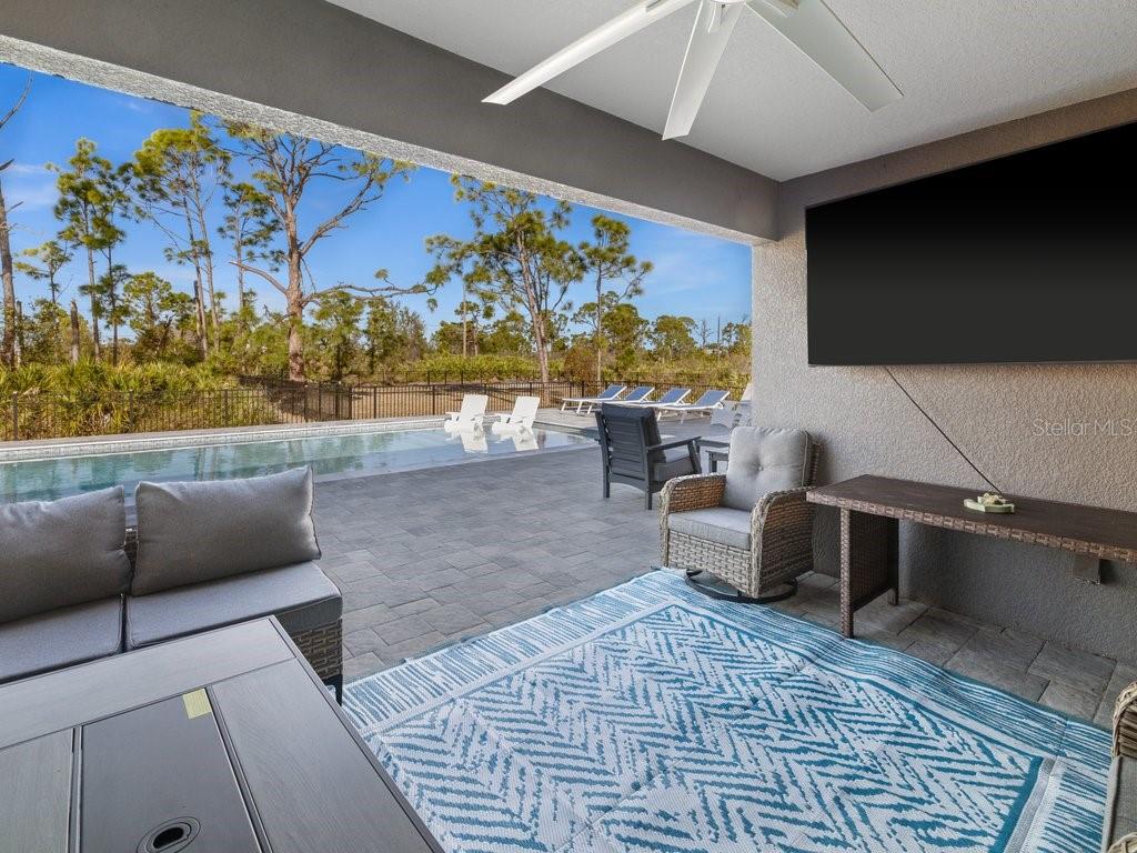 8221 Agate Street Port Charlotte, FL 33981 - Photo 26 of 50 a living room with furniture and a flat screen tv
