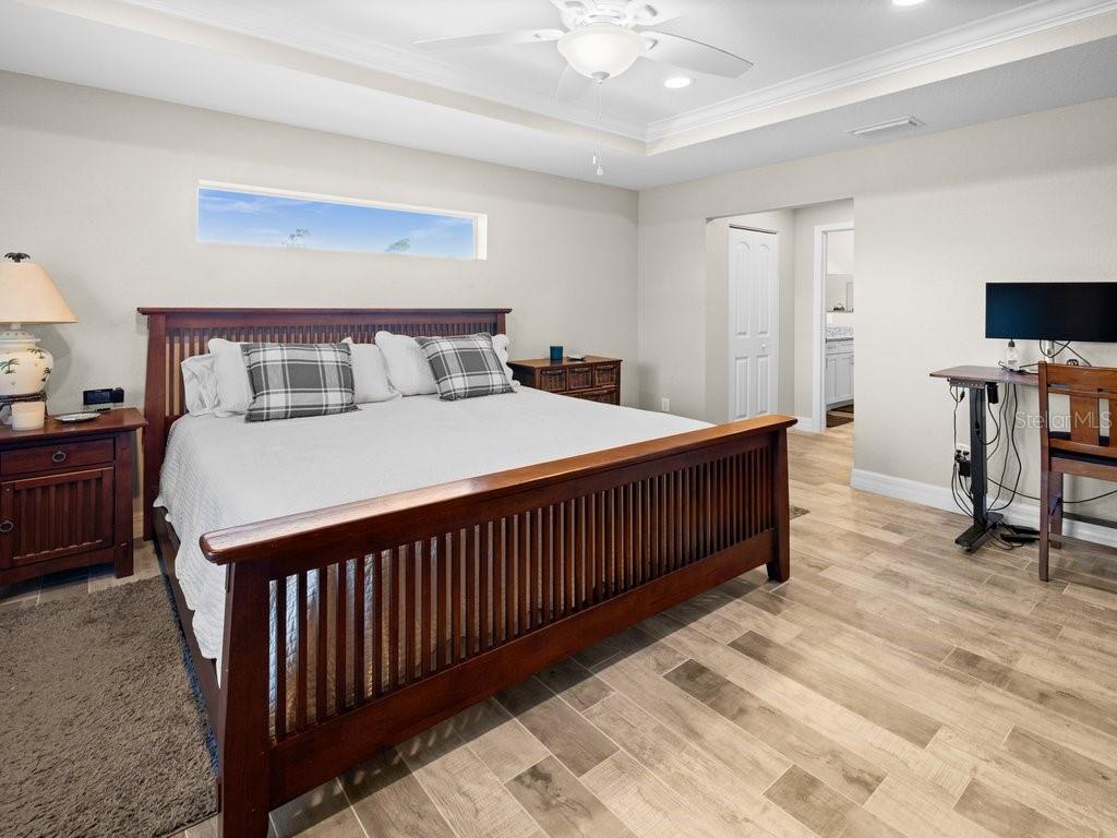 8221 Agate Street Port Charlotte, FL 33981 - Photo 28 of 50 a bedroom with a bed and a tv on table